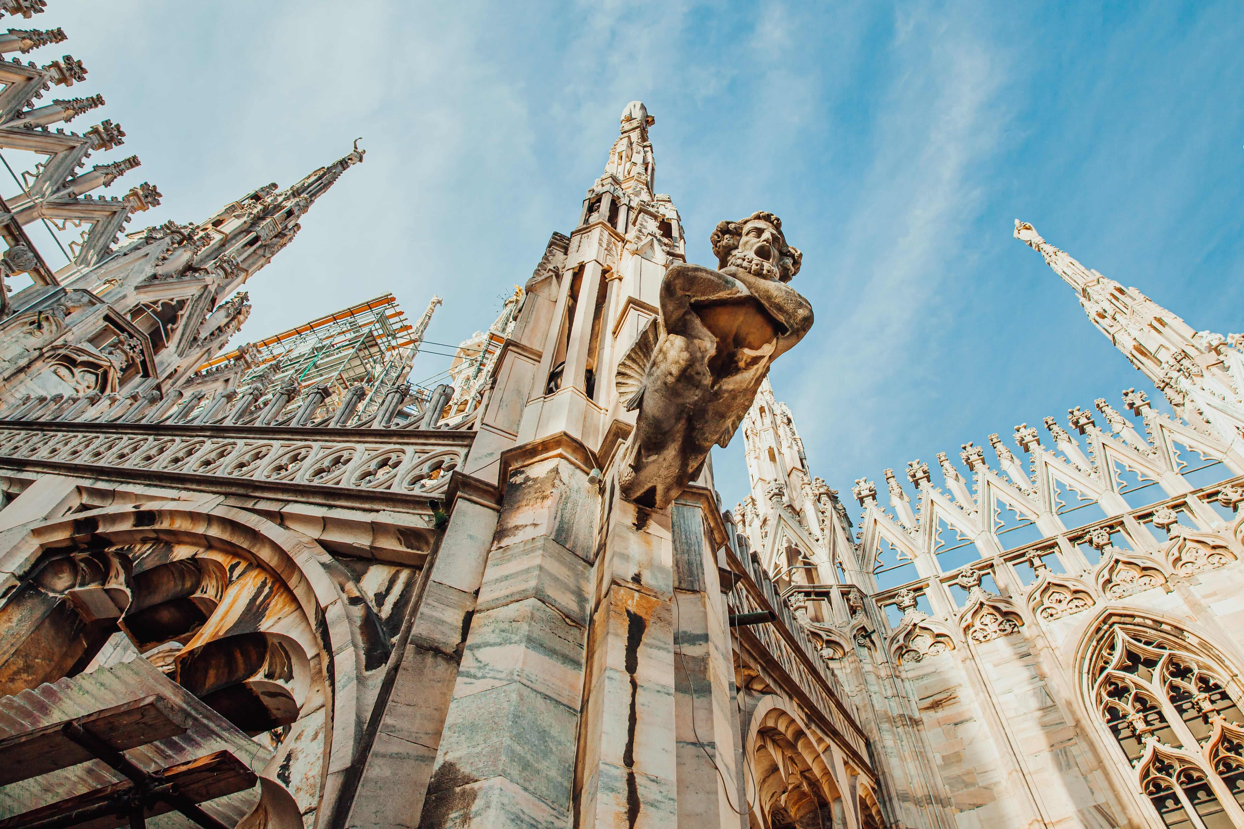 Roof of Milan Cathedral Duomo di Milano with Gothic spires and white marble statues